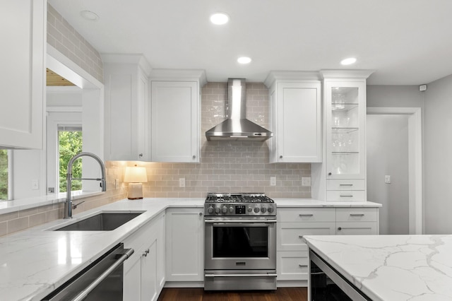 1541 Wexford Ct, Eagan, MN 55122 - kitchen featuring appliances with stainless steel finishes, wall chimney range hood, backsplash, white cabinets, and recessed lighting