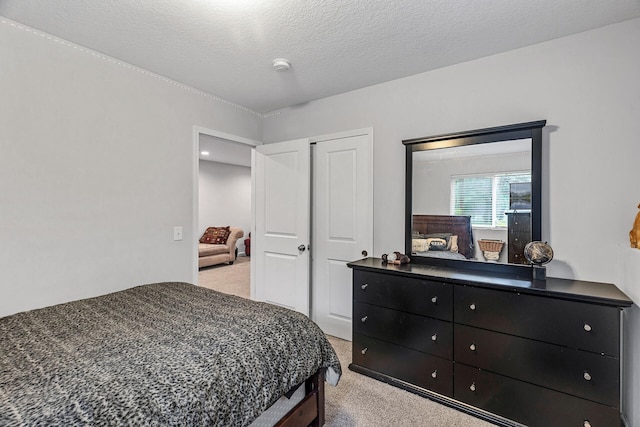 1227 Dupont Ln N, Brooklyn Park, MN 55444 - bedroom featuring light colored carpet, a closet, and a textured ceiling