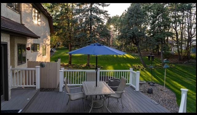 469 Lake Wabasso Ct, Shoreview, MN 55126 - deck with outdoor dining area and a yard