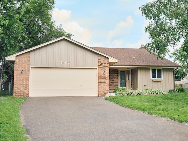 7467 Meadowwood Ct, Brooklyn Park, MN 55444 - view of front of home featuring brick siding, driveway, roof with shingles, and an attached garage