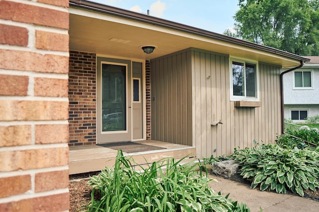 7467 Meadowwood Ct, Brooklyn Park, MN 55444 - doorway to property with brick siding