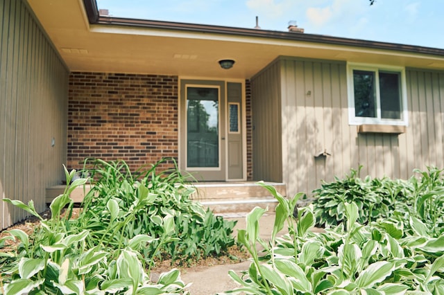 7467 Meadowwood Ct, Brooklyn Park, MN 55444 - doorway to property with brick siding