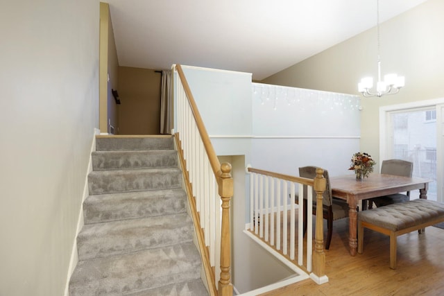 7467 Meadowwood Ct, Brooklyn Park, MN 55444 - stairs featuring a chandelier and wood finished floors