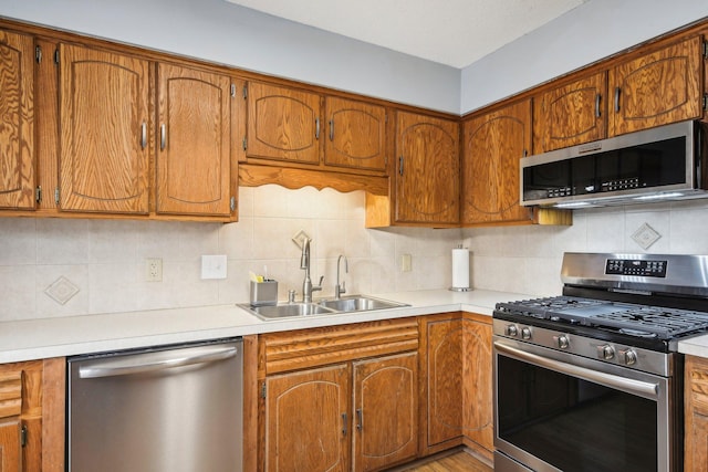 7467 Meadowwood Ct, Brooklyn Park, MN 55444 - kitchen with appliances with stainless steel finishes, light countertops, and brown cabinetry