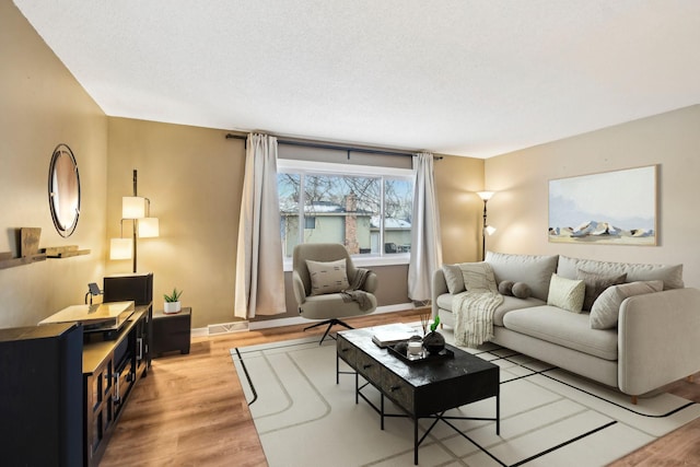 7467 Meadowwood Ct, Brooklyn Park, MN 55444 - living area featuring light wood finished floors and baseboards