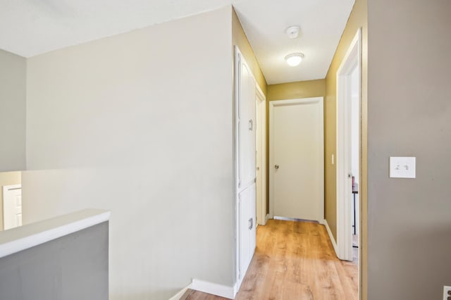 7467 Meadowwood Ct, Brooklyn Park, MN 55444 - hallway featuring light wood-type flooring and baseboards