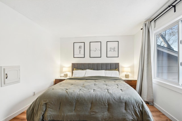 7467 Meadowwood Ct, Brooklyn Park, MN 55444 - bedroom featuring baseboards and wood finished floors