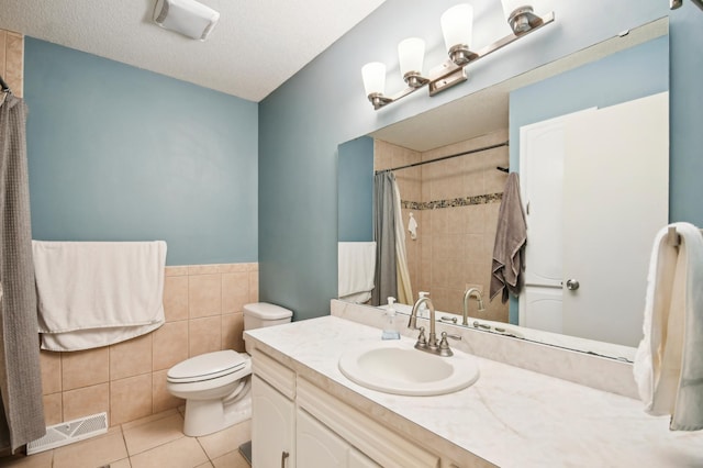 7467 Meadowwood Ct, Brooklyn Park, MN 55444 - bathroom with vanity, tile patterned floors, tile walls, a shower with curtain, and wainscoting