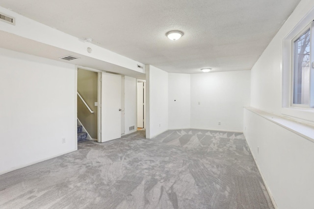 7467 Meadowwood Ct, Brooklyn Park, MN 55444 - carpeted empty room featuring a textured ceiling and stairway