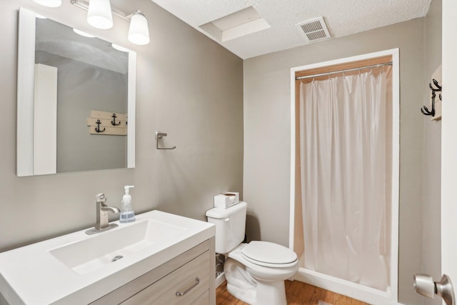 7467 Meadowwood Ct, Brooklyn Park, MN 55444 - bathroom with vanity, wood finished floors, a shower with shower curtain, and a textured ceiling