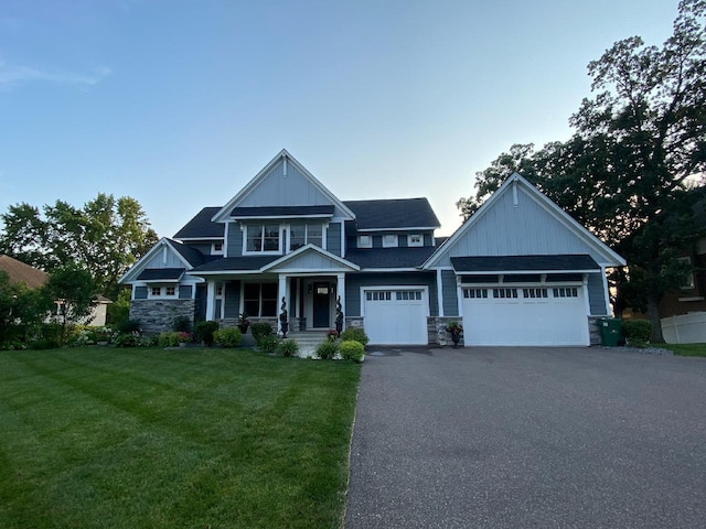 19803 Jersey Ave, Lakeville, MN 55044 - craftsman-style house featuring asphalt driveway, a front yard, stone siding, an attached garage, and board and batten siding