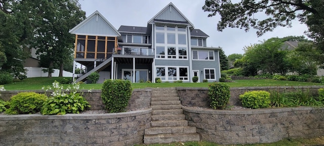 19803 Jersey Ave, Lakeville, MN 55044 - back of property with a sunroom, stairway, and a lawn