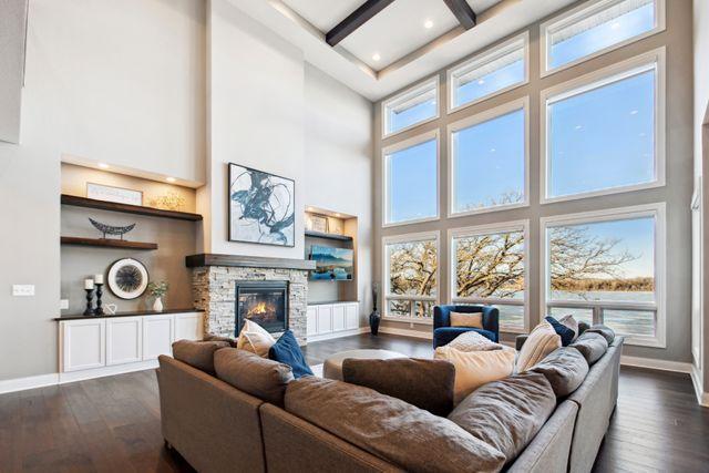 19803 Jersey Ave, Lakeville, MN 55044 - living area featuring a high ceiling, dark wood finished floors, beam ceiling, a fireplace, and recessed lighting