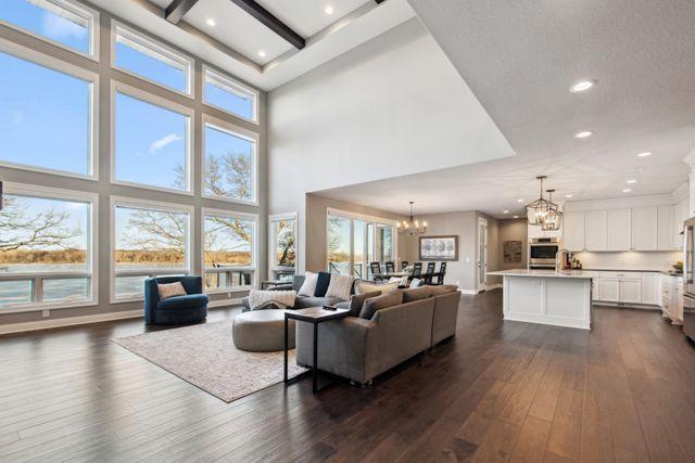 19803 Jersey Ave, Lakeville, MN 55044 - living room featuring a chandelier, dark wood finished floors, recessed lighting, and a high ceiling