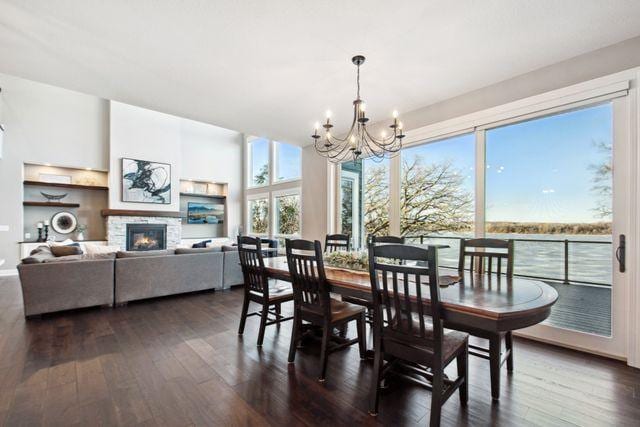 19803 Jersey Ave, Lakeville, MN 55044 - dining area with a chandelier, dark wood-style flooring, and a fireplace