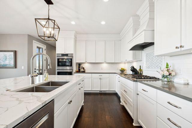 19803 Jersey Ave, Lakeville, MN 55044 - kitchen featuring stainless steel appliances, recessed lighting, white cabinets, dark wood-style floors, and a chandelier