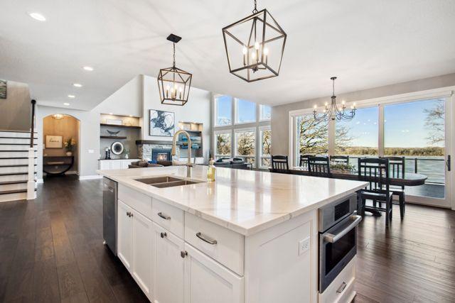 19803 Jersey Ave, Lakeville, MN 55044 - kitchen with a chandelier, healthy amount of natural light, dark wood-style flooring, recessed lighting, and stainless steel appliances