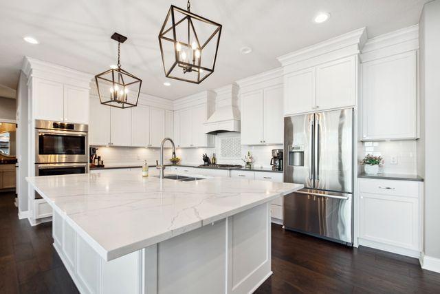 19803 Jersey Ave, Lakeville, MN 55044 - kitchen featuring appliances with stainless steel finishes, custom range hood, a chandelier, backsplash, and recessed lighting