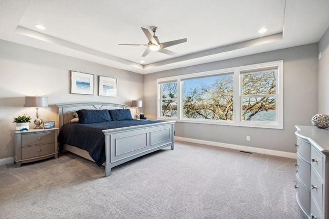 19803 Jersey Ave, Lakeville, MN 55044 - bedroom featuring a tray ceiling, light carpet, recessed lighting, and a ceiling fan