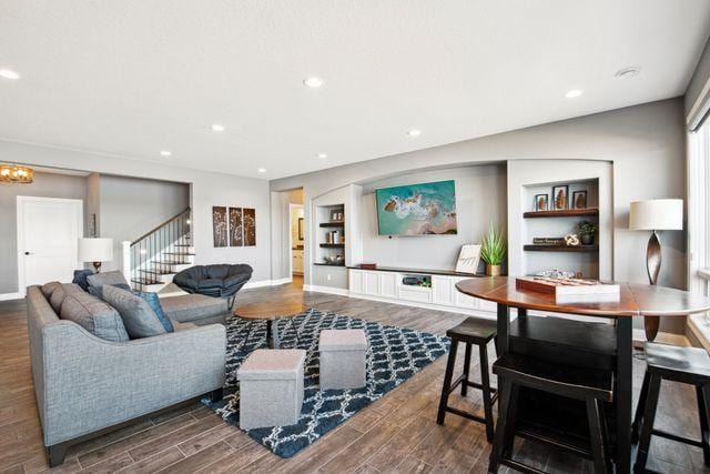 19803 Jersey Ave, Lakeville, MN 55044 - living area featuring wood finished floors, recessed lighting, a chandelier, and stairs