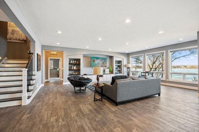 19803 Jersey Ave, Lakeville, MN 55044 - living area featuring wood finished floors, a textured ceiling, stairway, and recessed lighting
