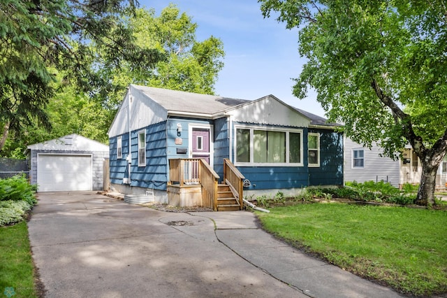 1130 Oak St N, Fargo, ND 58102 - bungalow-style home with an outdoor structure, concrete driveway, a garage, and a front yard