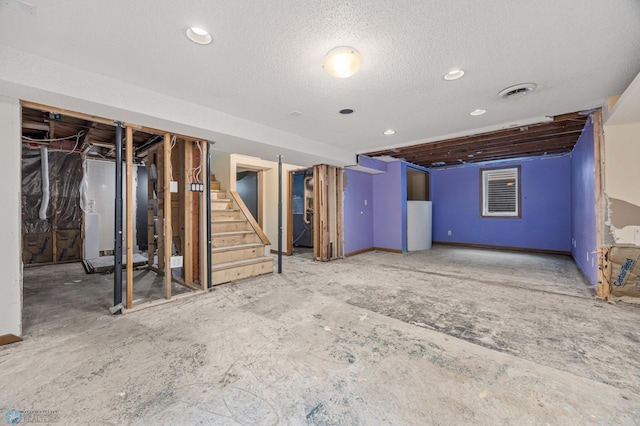 1130 Oak St N, Fargo, ND 58102 - below grade area featuring stairway, a textured ceiling, water heater, and recessed lighting