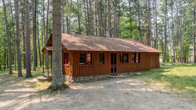 13000 Inlet Cir, Park Rapids, MN 56470 - view of front of property with a shingled roof, a wooded view, and a chimney