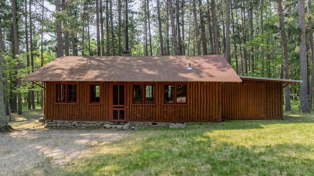 13000 Inlet Cir, Park Rapids, MN 56470 - rustic home with a front lawn, a shingled roof, and a forest view