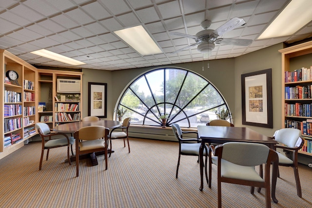 6500 Woodlake Dr Unit 1006, Richfield, MN 55423 - carpeted office featuring a wall mounted AC, a ceiling fan, built in shelves, and a baseboard heating unit