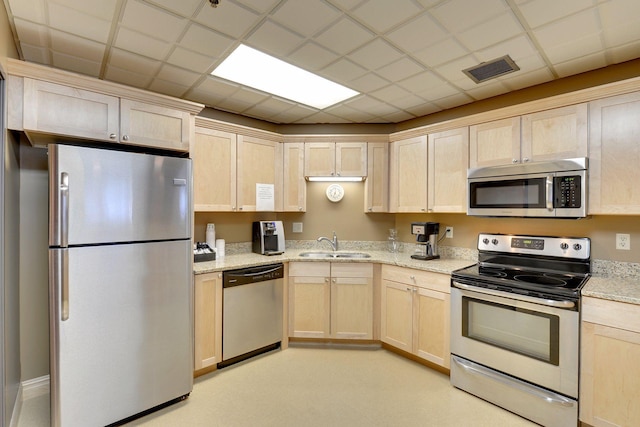 6500 Woodlake Dr Unit 1006, Richfield, MN 55423 - kitchen featuring stainless steel appliances, light brown cabinets, light stone counters, and a drop ceiling