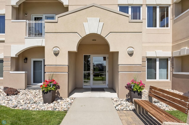 2501 30th Ave S Unit 203, Fargo, ND 58103 - property entrance with stucco siding, a balcony, and french doors