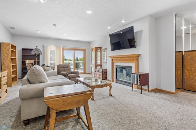 2501 30th Ave S Unit 203, Fargo, ND 58103 - living room with carpet floors, a textured ceiling, a glass covered fireplace, and recessed lighting