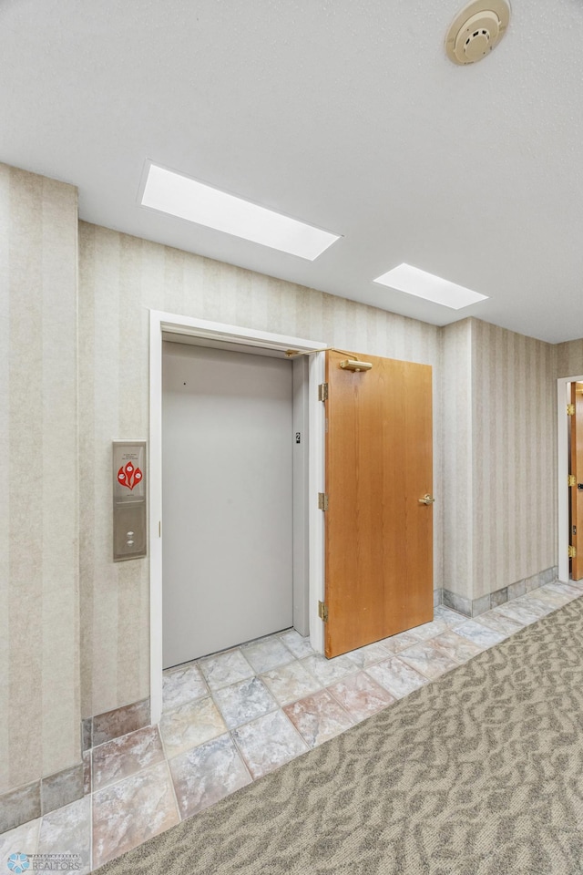 2501 30th Ave S Unit 203, Fargo, ND 58103 - corridor featuring wallpapered walls, a skylight, and elevator