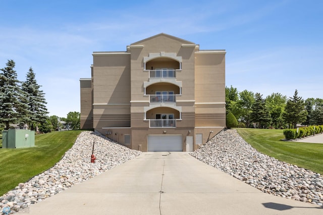 2501 30th Ave S Unit 203, Fargo, ND 58103 - view of building exterior featuring driveway and a garage
