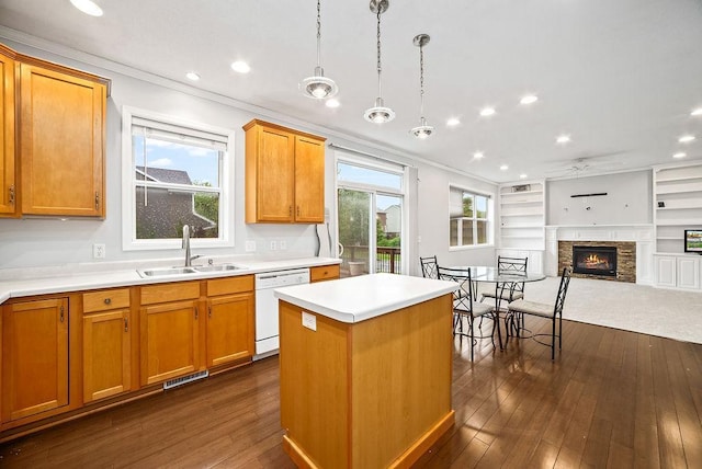 6800 Troy Ln N, Maple Grove, MN 55311 - kitchen featuring white dishwasher, a stone fireplace, dark wood-style floors, a center island, and crown molding