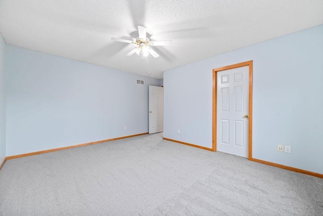 6800 Troy Ln N, Maple Grove, MN 55311 - unfurnished bedroom with light colored carpet, a textured ceiling, and ceiling fan