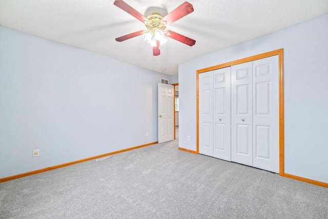 6800 Troy Ln N, Maple Grove, MN 55311 - unfurnished bedroom with carpet floors, a textured ceiling, a closet, and ceiling fan
