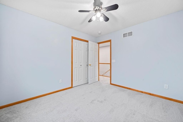 6800 Troy Ln N, Maple Grove, MN 55311 - unfurnished bedroom with carpet, a closet, a ceiling fan, and a textured ceiling