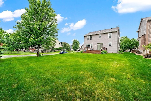 6800 Troy Ln N, Maple Grove, MN 55311 - view of grassy yard featuring a deck