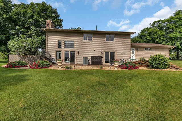 1506 Jackson Ave NE, Saint Michael, MN 55376 - rear view of property featuring a yard, a chimney, and stairs