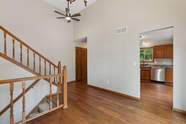 4552 131st St, Savage, MN 55378 - stairs with wood finished floors, a ceiling fan, and a high ceiling