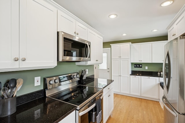 3300 88th St, Bloomington, MN 55431 - kitchen with stainless steel appliances, white cabinetry, light wood-type flooring, dark stone countertops, and recessed lighting