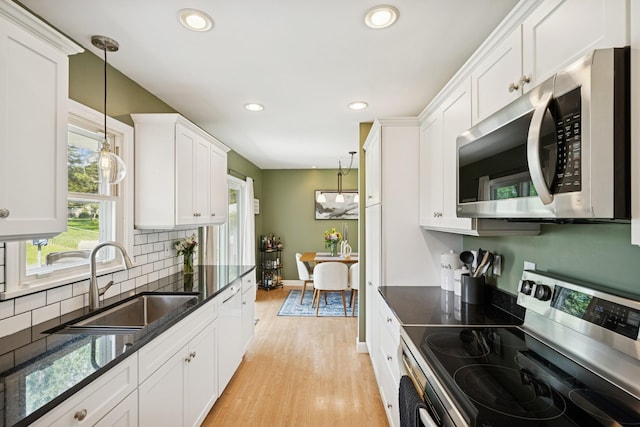 3300 88th St, Bloomington, MN 55431 - kitchen featuring stainless steel appliances, white cabinets, recessed lighting, decorative backsplash, and dark stone countertops