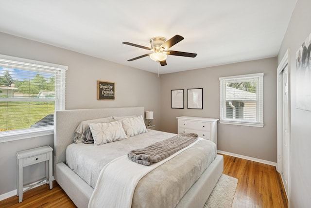 3300 88th St, Bloomington, MN 55431 - bedroom with multiple windows, light wood-style floors, a closet, and ceiling fan