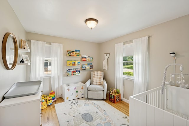 3300 88th St, Bloomington, MN 55431 - bedroom featuring a nursery area and light wood-type flooring