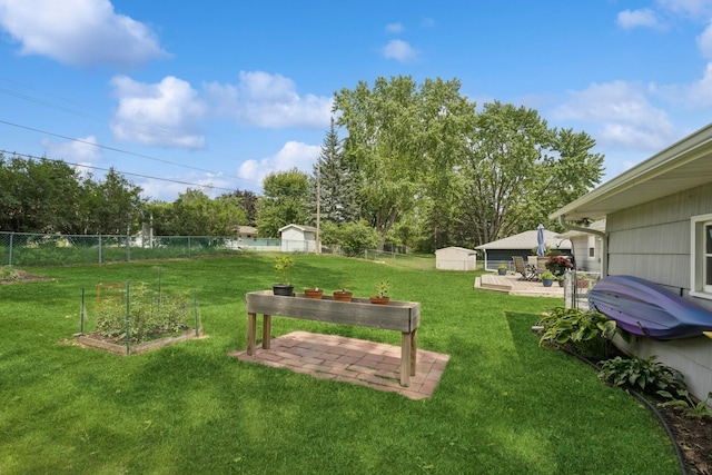 3300 88th St, Bloomington, MN 55431 - fenced backyard with a shed, a vegetable garden, a patio area, and view of scattered trees