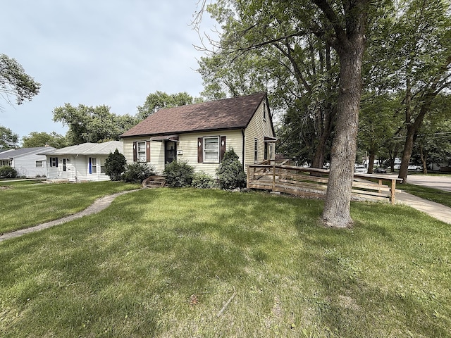 1202 4th St, Montevideo, MN 56265 - view of front of home with a front lawn, roof with shingles, and a deck