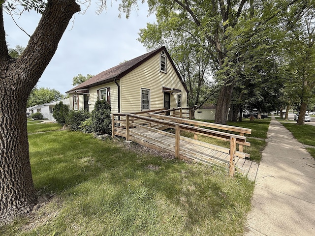 1202 4th St, Montevideo, MN 56265 - view of home's exterior featuring a lawn and a shingled roof