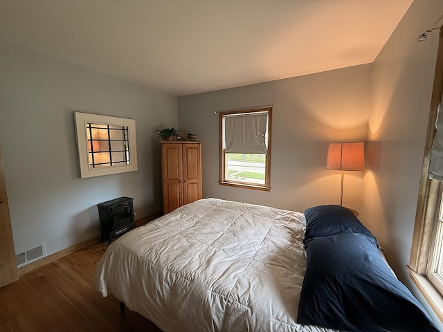 1202 4th St, Montevideo, MN 56265 - bedroom with wood finished floors and a wood stove